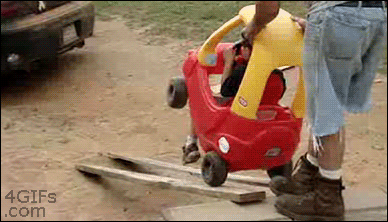 1 - GIF of dad putting his kid in a toy car on a ramp that crashes.