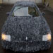 This Maserati has been covered in shattered glass by an artist; it is now on display in an art gallery.
