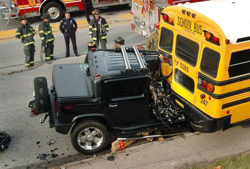 This Hummer is totaled by a school bus!