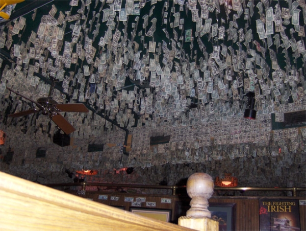 McGuire's Irish Pub, over $550,000 in dollar bills stuck on the walls and ceiling. The story goes that Molly, the first waitress, took her first dollar tip and tacked it on the wall.