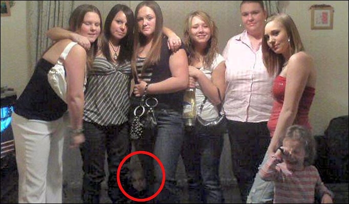 This ghost was caught on a cell phone cam in the middle of the picture.  Real or Fake? You decide!