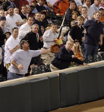 audience at an mlb game avoiding a flying bat
