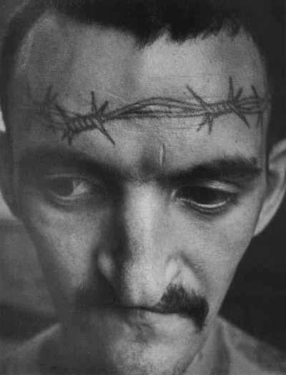 Barbed wire tattooed across the forehead signifies a sentence of life imprisonment without possibility of parole.
