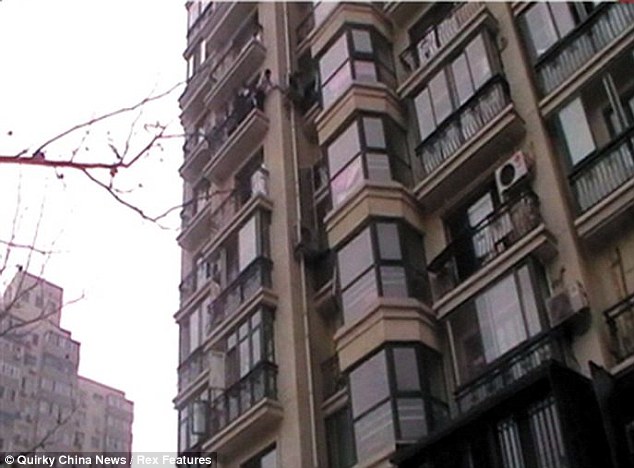 Long way down: Rescuers reached the boy from a seventh floor balcony after he fell from his apartment one floor up
