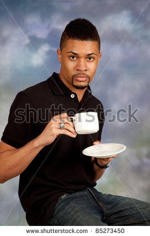 handsome black man drinking coffee with strong eye contact - shu sack 85273450