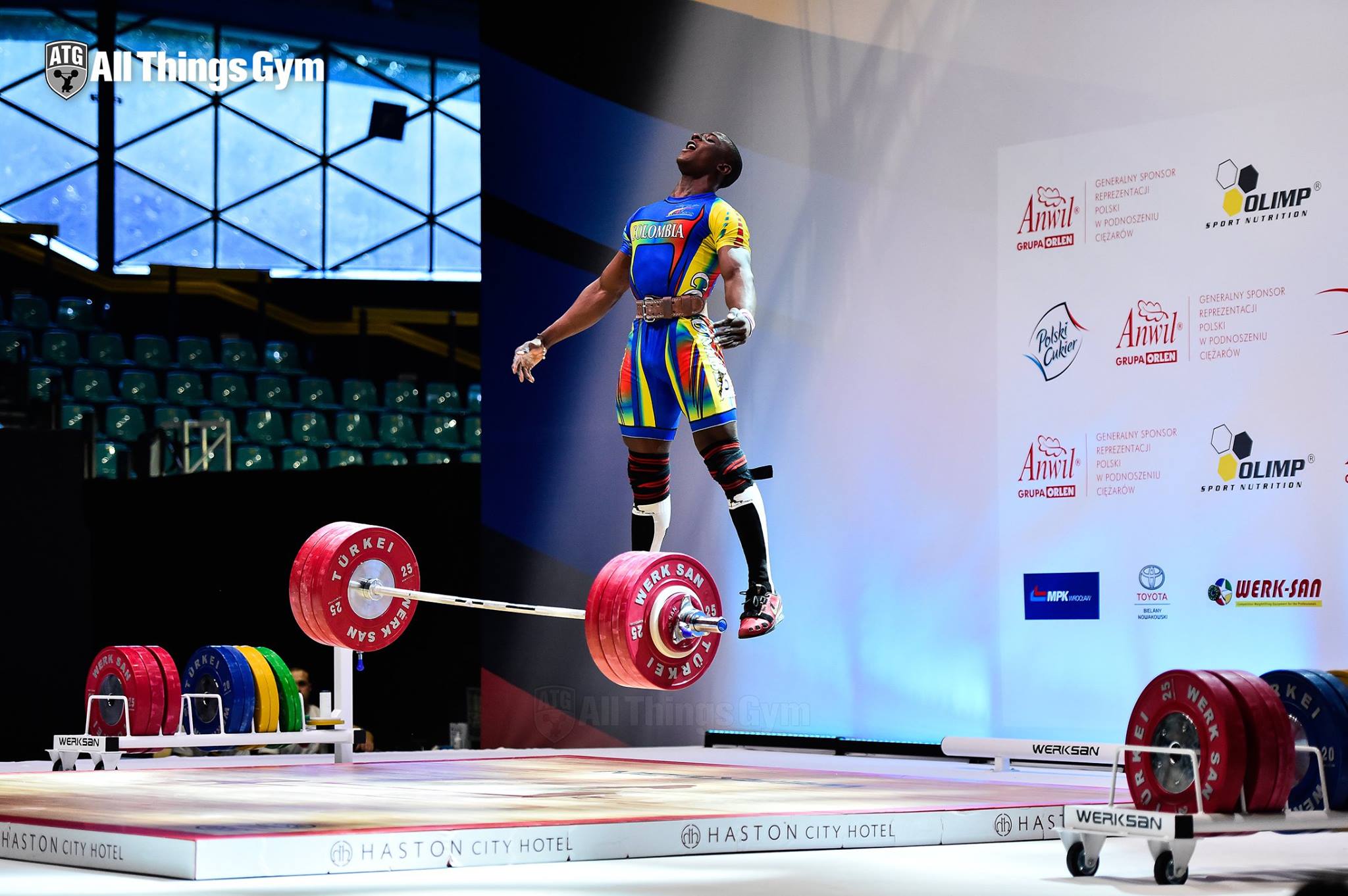 funny picture of weight lift competitor appearing to fly away in a picture as he drops the barbell