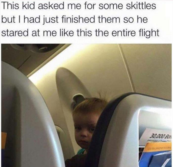 kid asked me for some skittles - This kid asked me for some skittles but I had just finished them so he stared at me this the entire flight 30,000 Ba