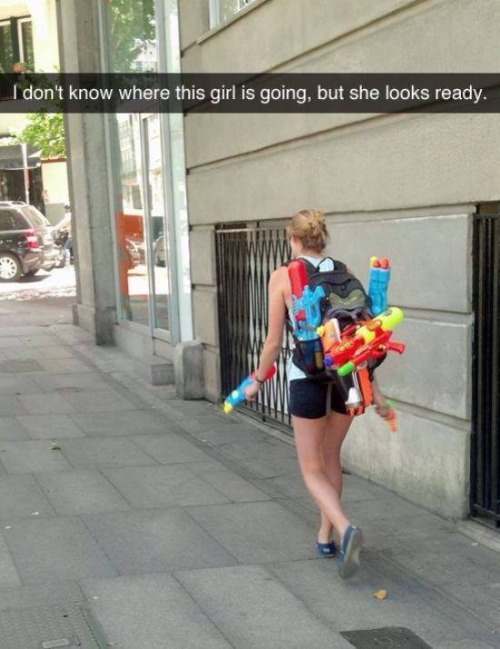 water gun funny - I don't know where this girl is going, but she looks ready.