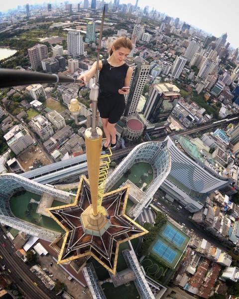 Girl atop a tower taking a selfie