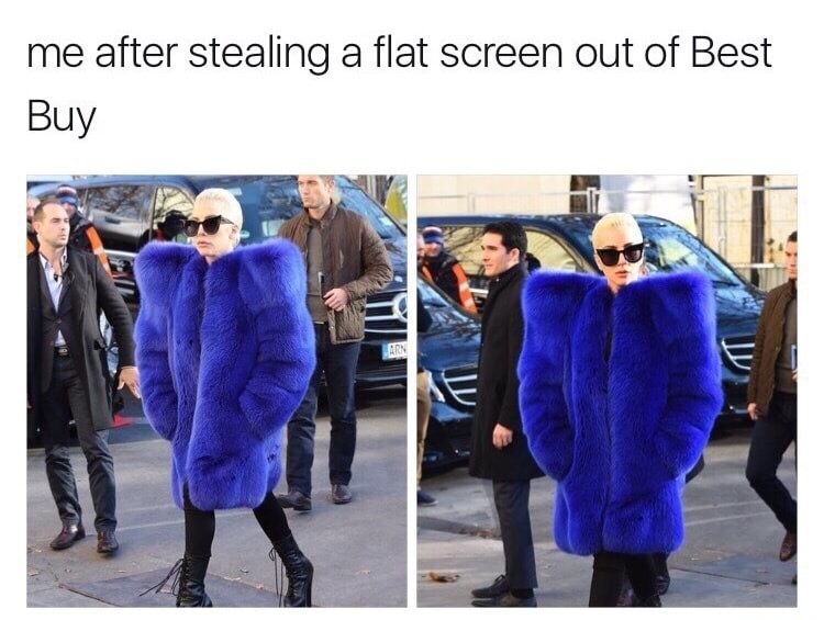 Woman wearing bright blue fur coat that looks like she is smuggling a flat screen TV under there.