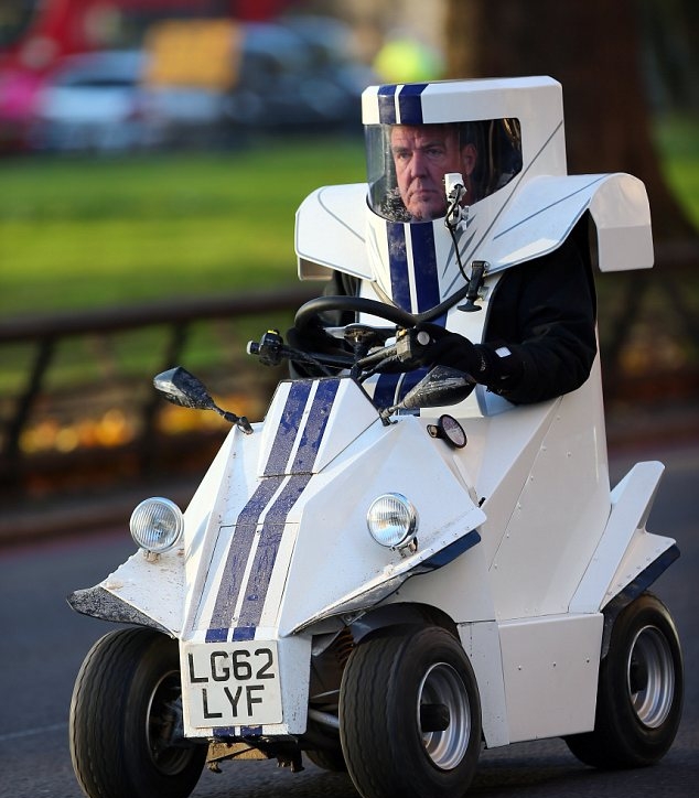 Jeremy Clarkson driving around in a very small car that he is practically wearing.