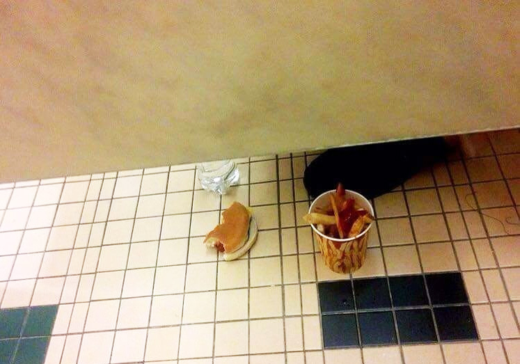 Someone eating sad version of McDonald's off the bathroom floor.
