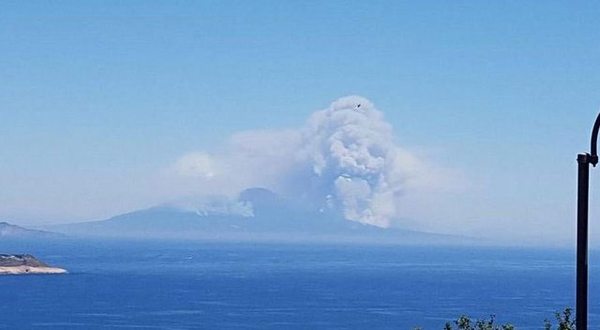 Volcano exploding that has a cloud look like a skull of possessed witch.