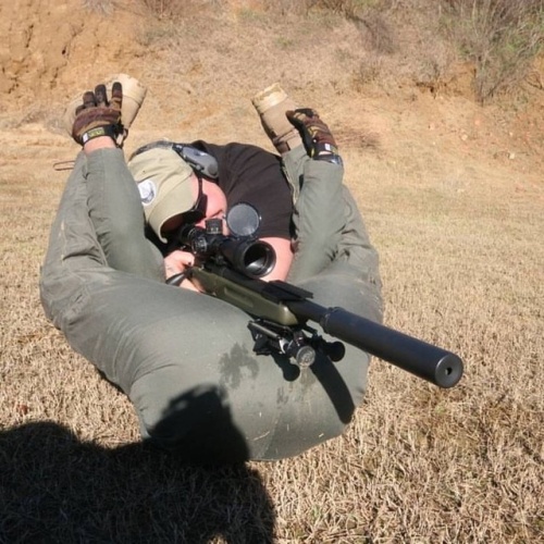 Sniper team with the shot being taken between the legs of the spotter.