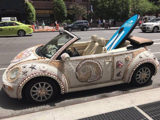 Surfboard in the back of an awesome Beetle car