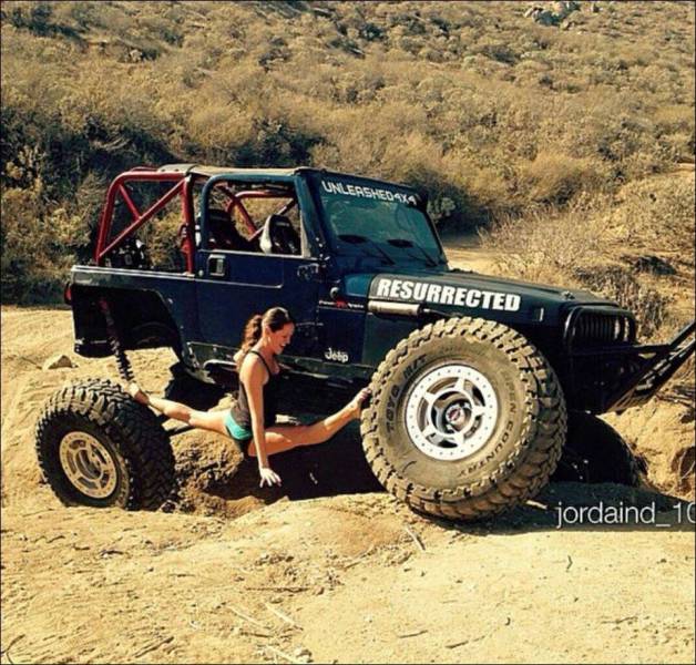 Girl does the splits on jeep stuck in the mud