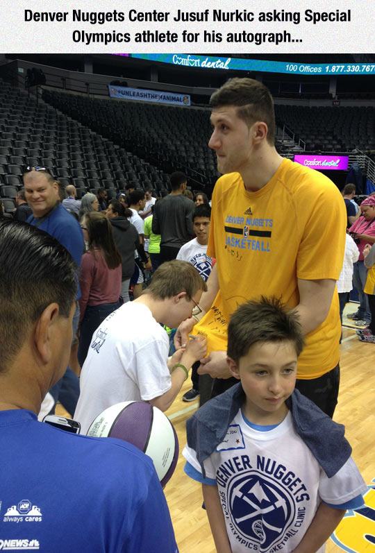 NBA player asking special olympics athlete for his autograph
