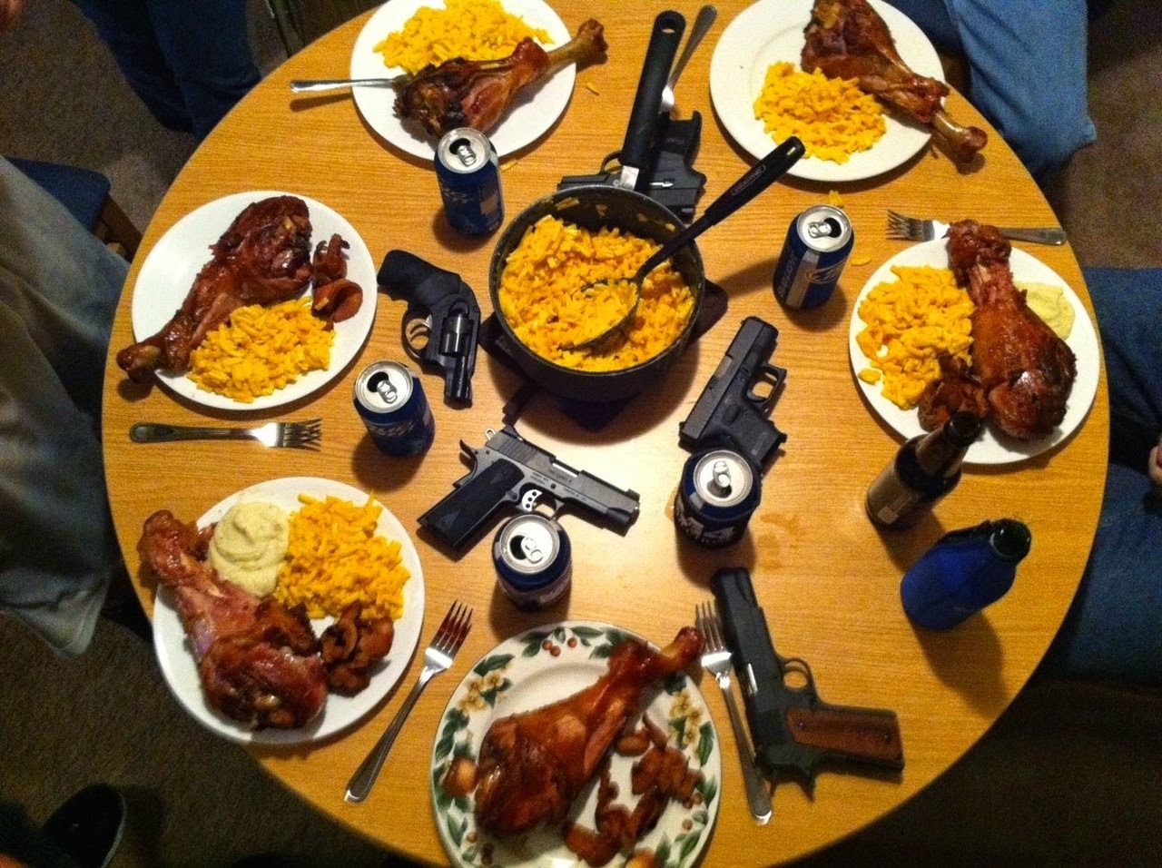 round table with manly drumsticks and a gun on each plate.