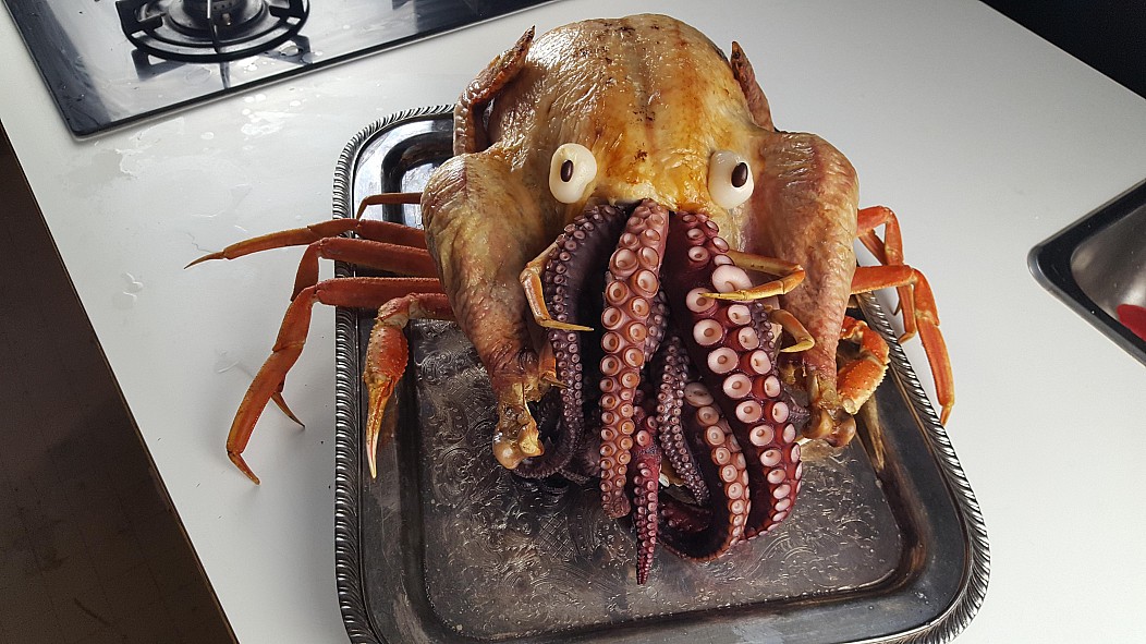 Turkey with octopus stuffed inside on top of a large crab that makes it look like alien