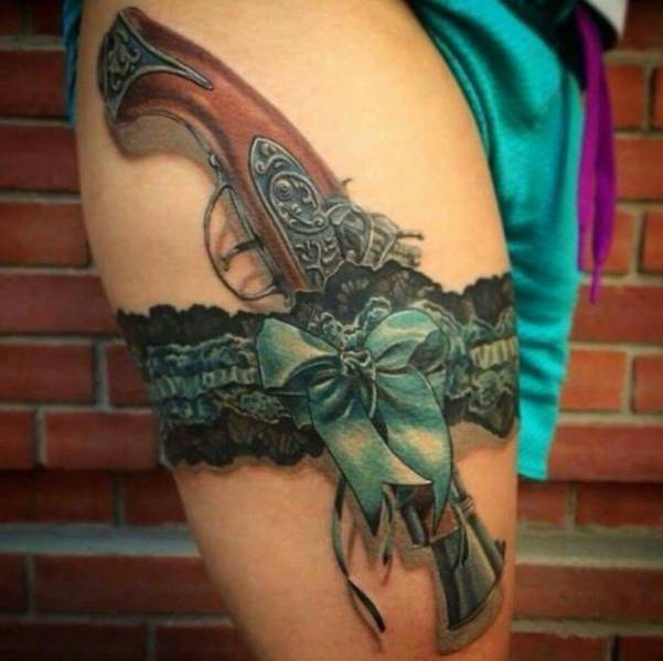 garter and gun tattoo