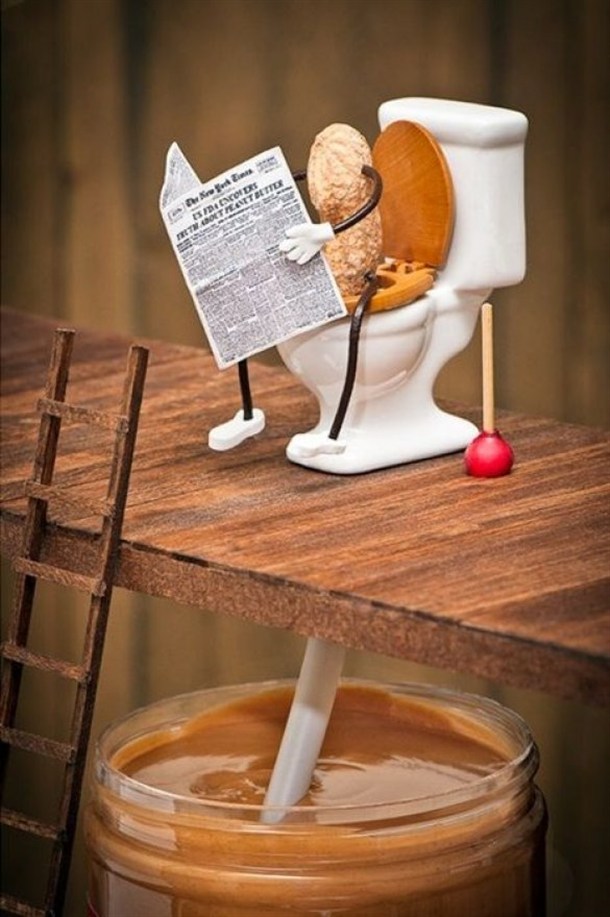 funny picture of a peanut pooping into a jar of peanut butter
