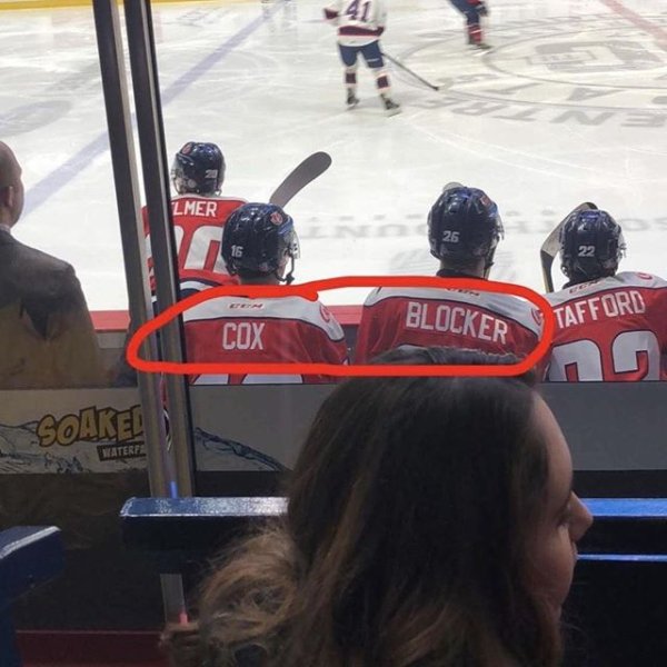 hockey game with cox and blocker sitting on the bench, viewable from the bleechers