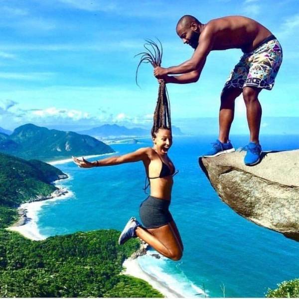 carefree funny pics of - carefree funny pics of a man holding woman over cliff