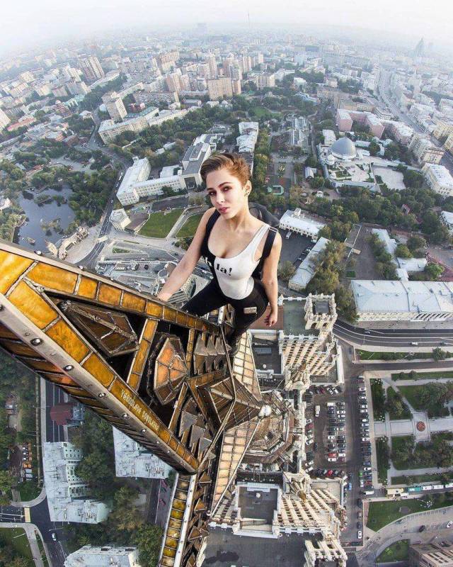 carefree funny pics of - woman posing against a building