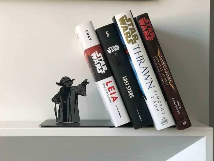 cool looking yoda bookshelf holders that makes it seem like he is using the force to keep the books from tipping over