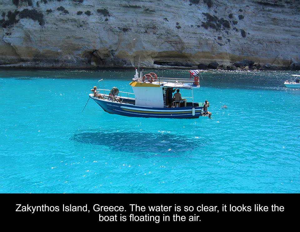 mind boggles - Zakynthos Island, Greece. The water is so clear, it looks the boat is floating in the air.