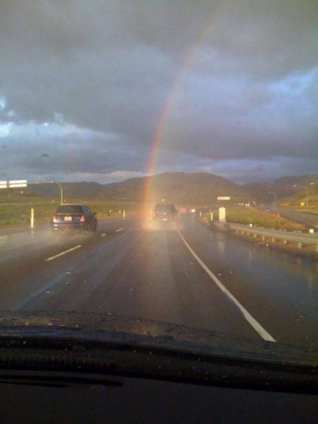 rainbow right in the middle of the road