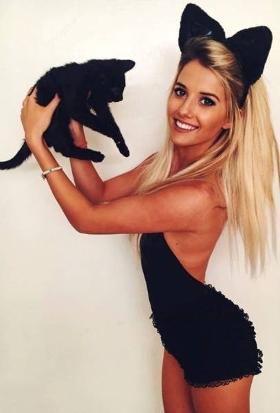 cute girl wearing cat outfit and holding a cat