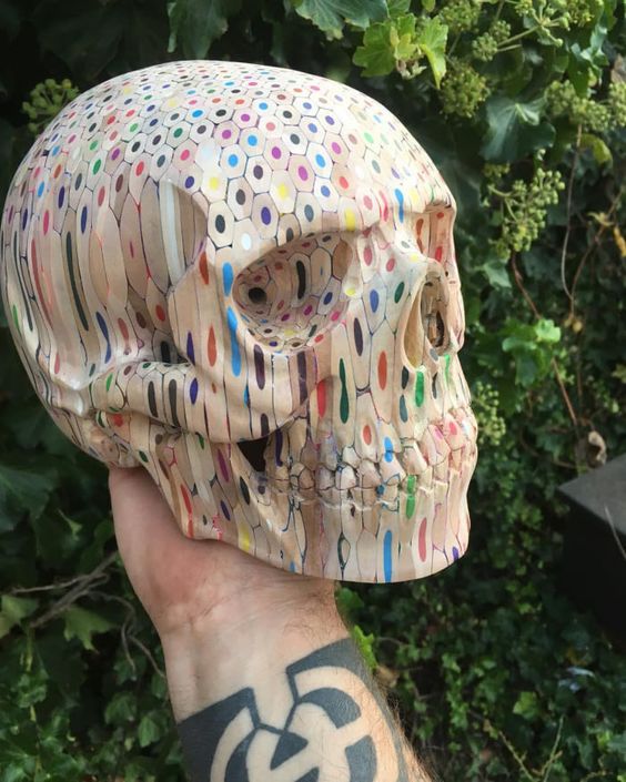 Skull sculpted out of colorful pencils