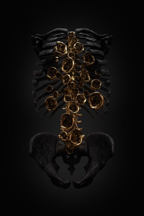 gold roses growing out of charred skeleton torso