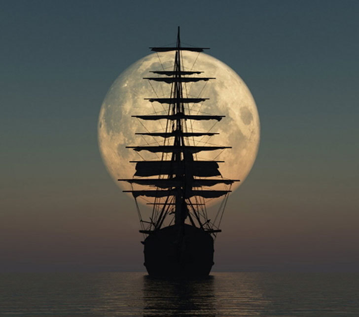 sailboat across the rising moon