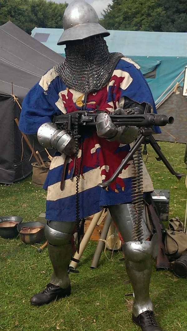 chainmail medieval warrior with machine gun
