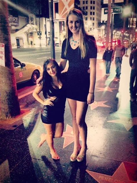 very tall and very short girl pose for a picture