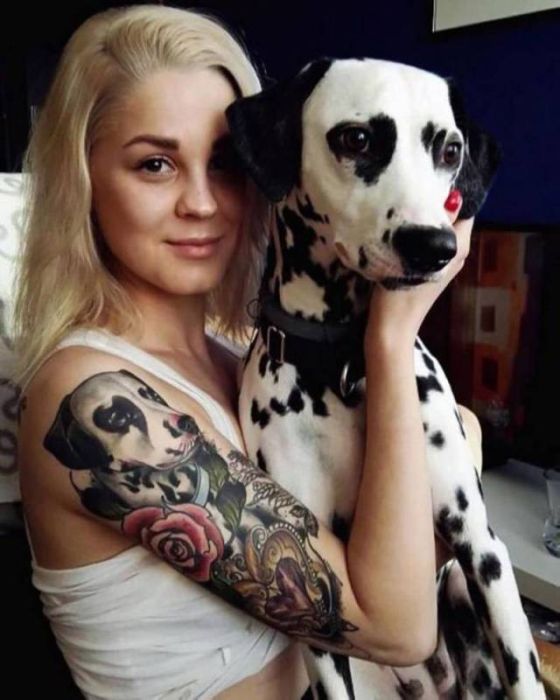 girl with dalmation tattoo on her arm holding dalmatian