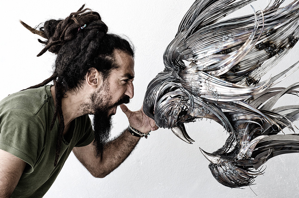 artist with a sculpture of a roaring lion