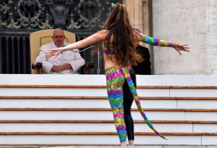 cat girl cosplayer gesturing openly to the pope