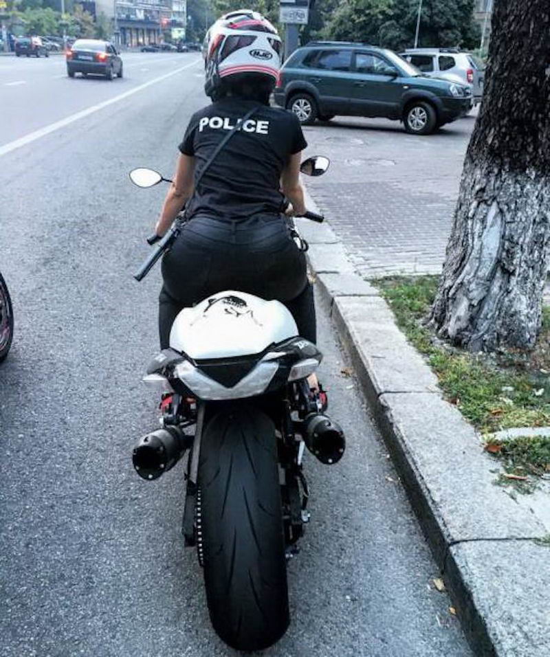 hot girl on bike with Police on her shirt