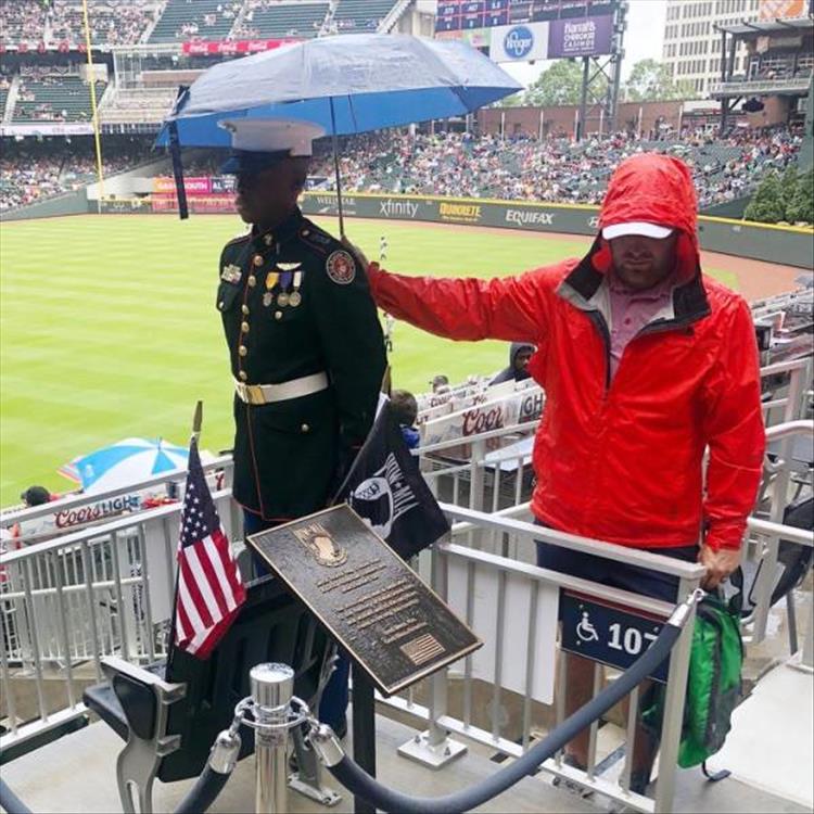 heartwarming man holds umbrella over marine