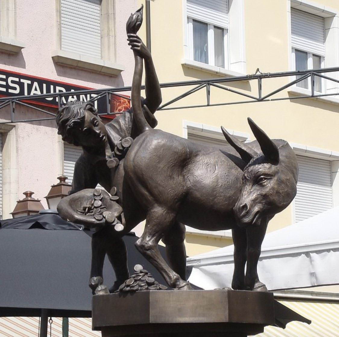 funny statue of a donkey pooping out money