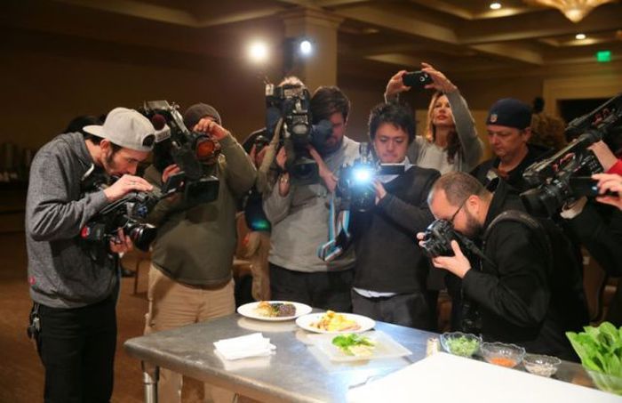 Photographers converging on a food item