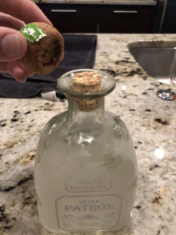 glass bottle with cork stuck in it