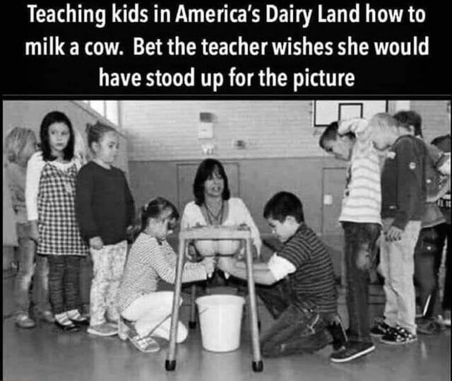 human behavior - Teaching kids in America's Dairy Land how to milk a cow. Bet the teacher wishes she would have stood up for the picture