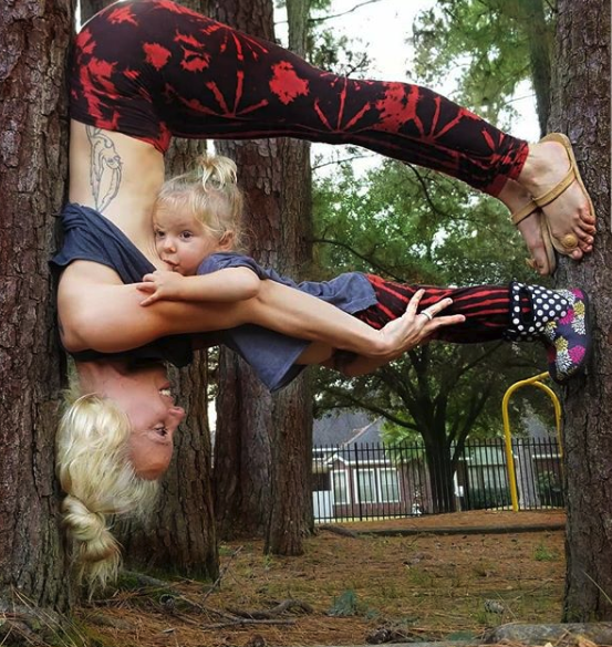 yoga mom breastfeeding on a tree