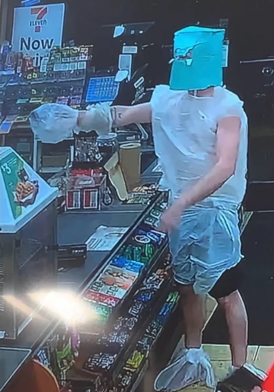 man in trash bag robbing a gas station