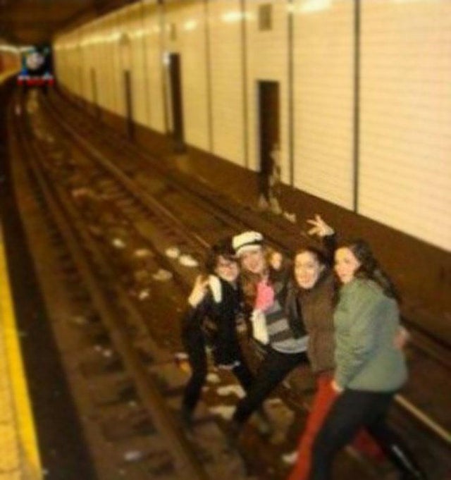 weird picture - darwin awards - girls in a train track