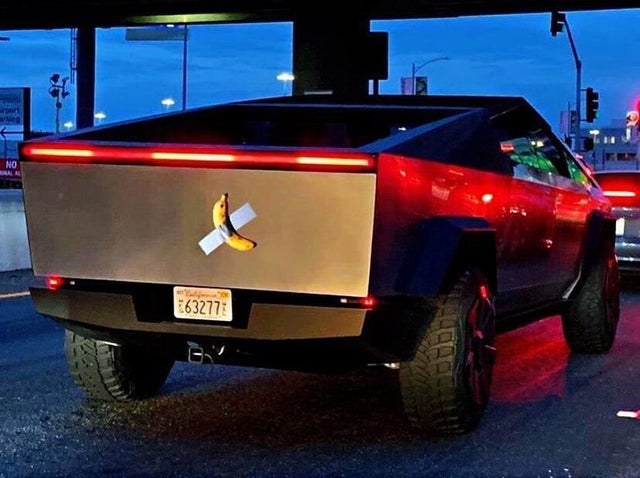 weird picture - tesla cybertruck with a banana taped to it.